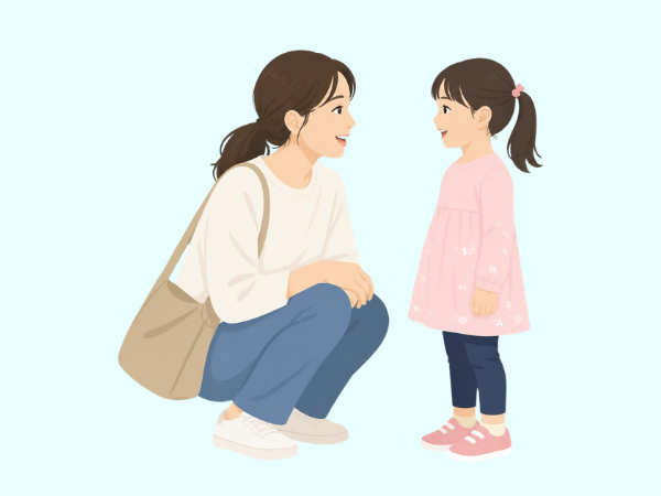 しゃがんでこどもと同じ目線で話しかける母親