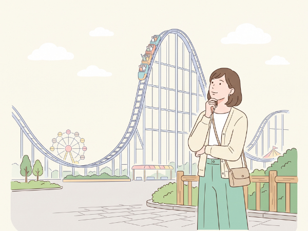 アトラクションのどれに乗ってみようかと考えている女性